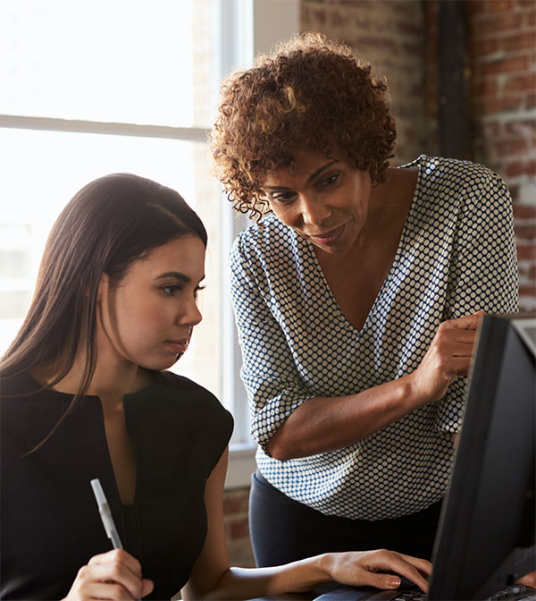 lady teaching a younger girl